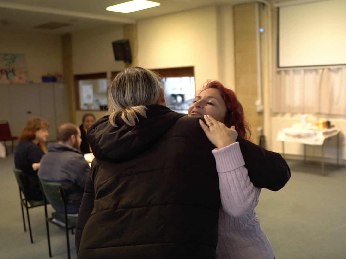 Kids Matter facilitator hugging mum at parenting group