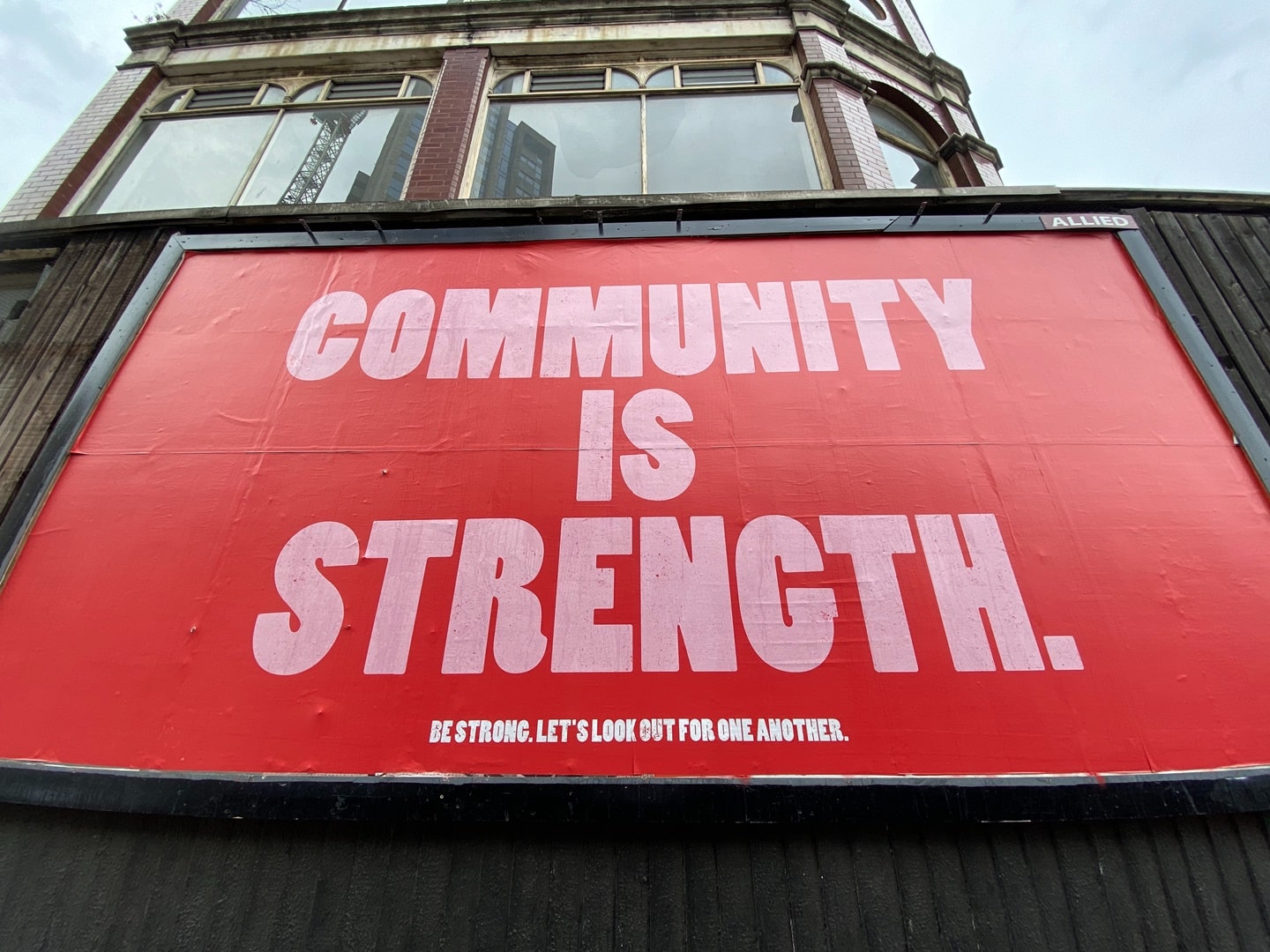 community is strength street sign