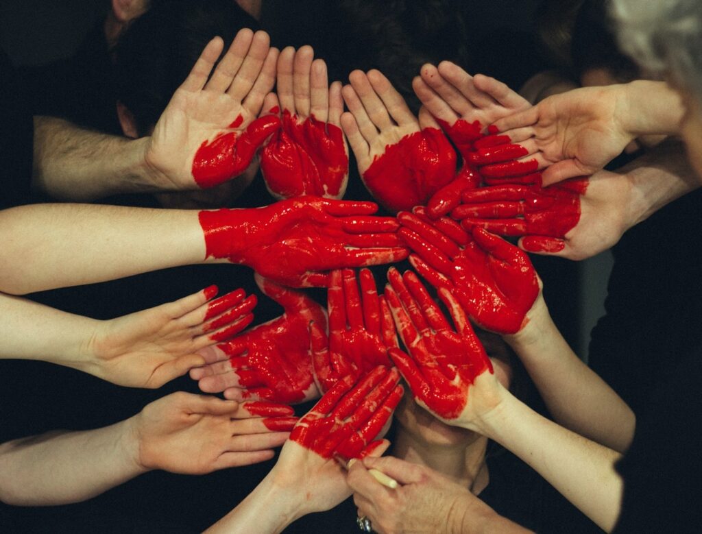 red heart created by many hands
