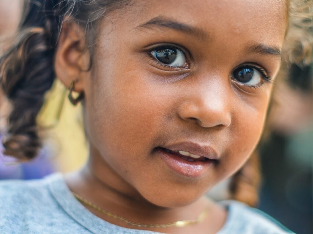 close up of smiling girl with big brown eyes