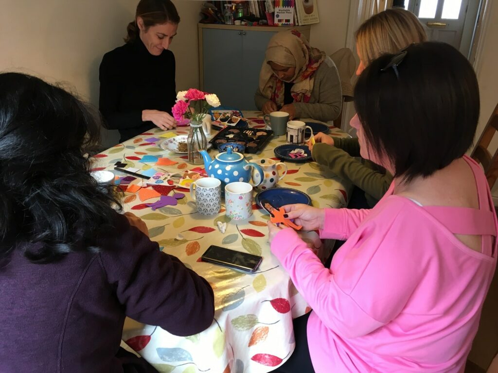 women doing crafts around a table