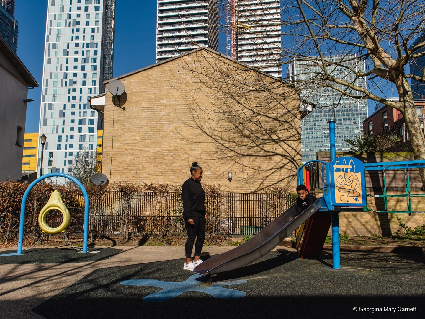 mom and child at a playground in Tower Hamlets in London